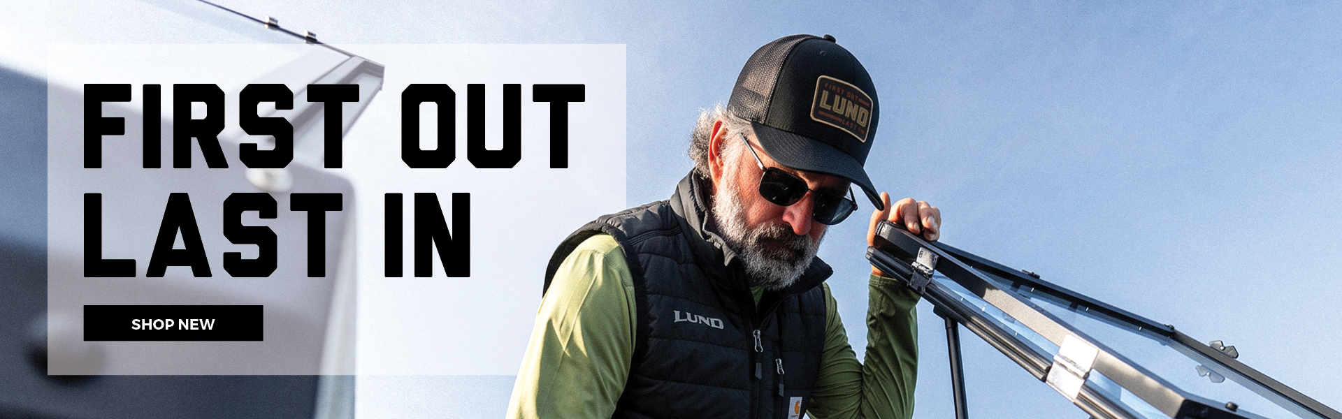 First Out Last In text and Shop New button overlaying a photo of a man on a Lund Boat wearing Lund gear.